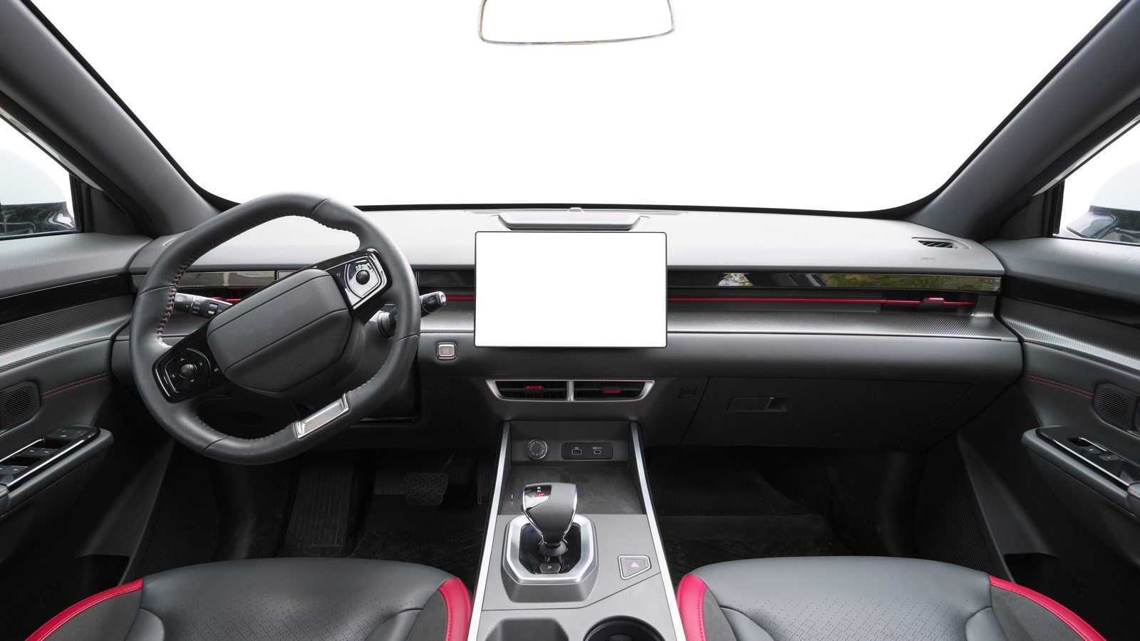 The empty front cabin of a modern car, with a steering wheel and a large blank center screen.